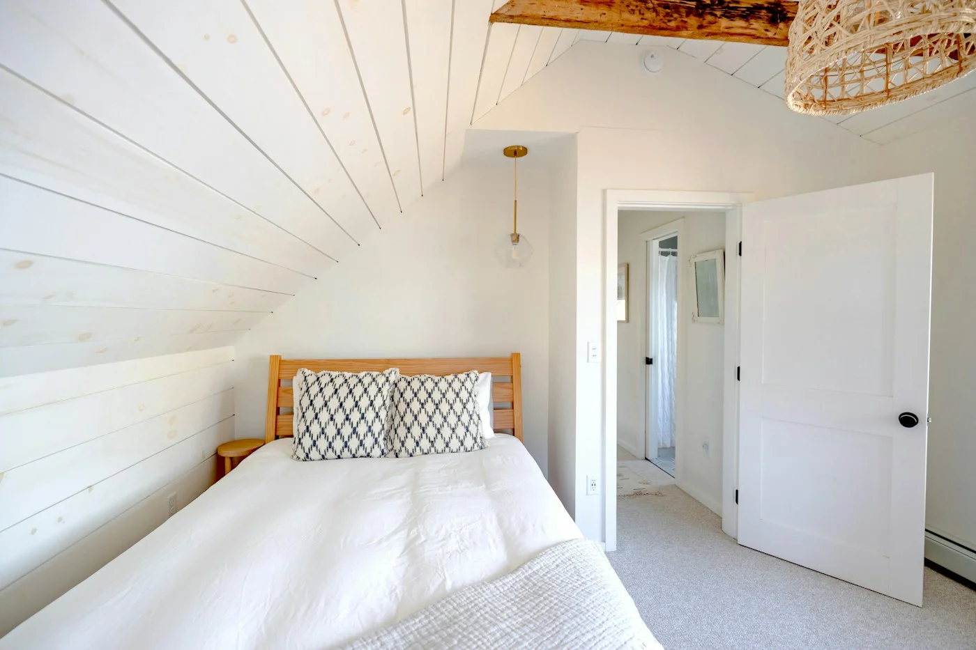 Airy bedroom with white walls and natural light