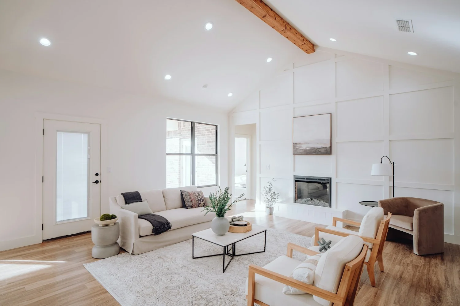 Bright living room with white walls, ceiling and painted trim